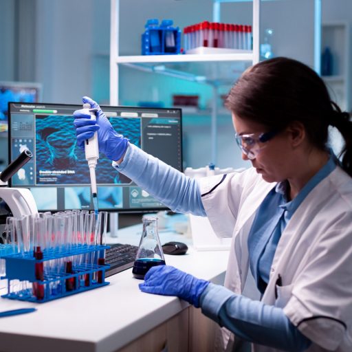 Medical engineer scientist uses micropipette, pipette taking sample from test tube Medical engineer scientist uses micropipette, pipette taking sample from test tube. Woman research a new experiment in modern lab, analyzing pharmaceutical work with modern equipment.